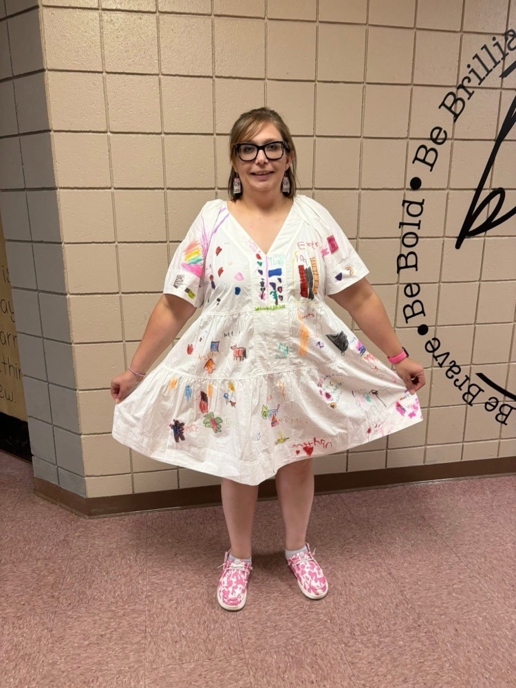 teacher wearing a dress that kindergarteners decorated