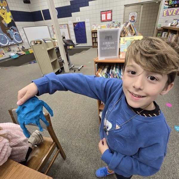 student with playdough creatures