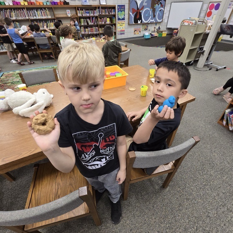 student with playdough creatures