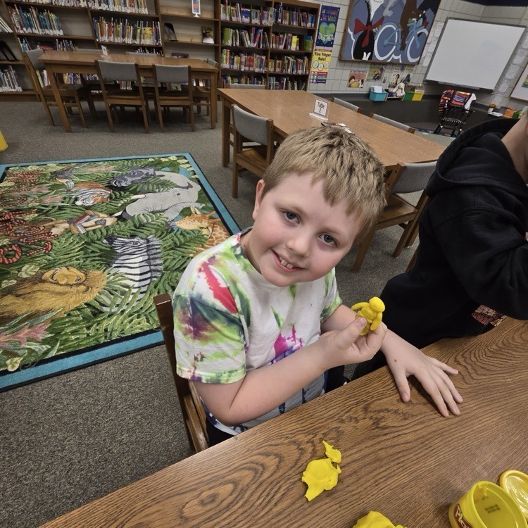 student with playdough creatures