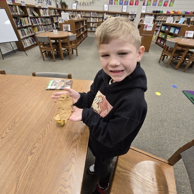student with playdough creatures