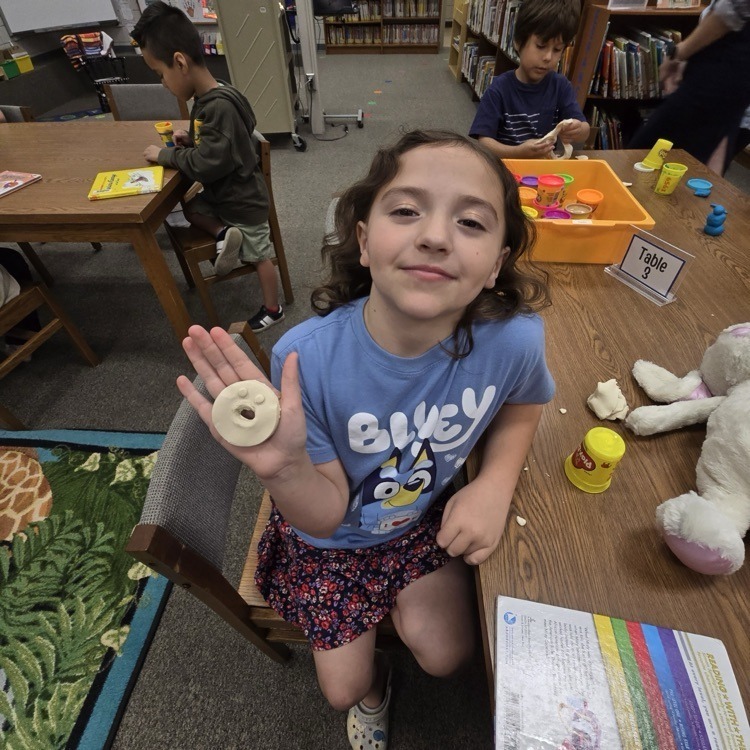student with playdough creatures