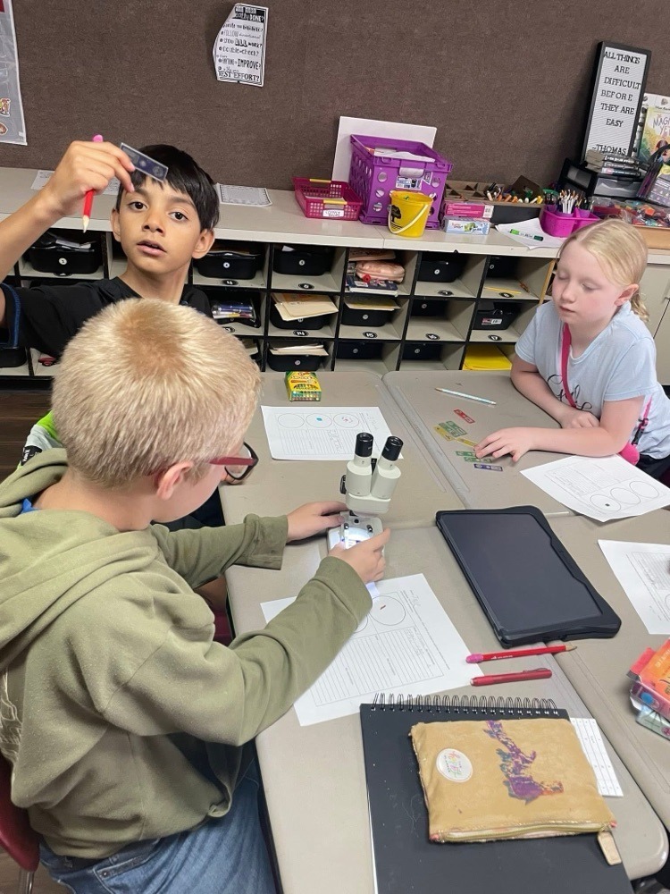 students with a microscope