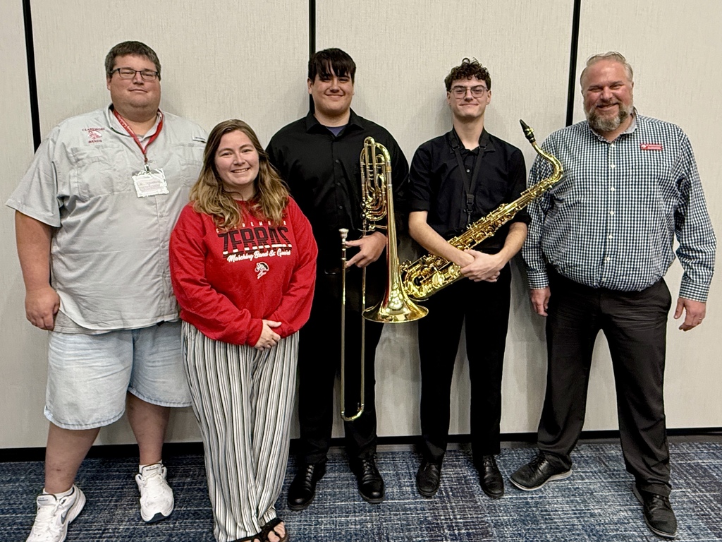Logan and Harrison smiling with Dr. Adkins, Mrs. Acord and Jazz director of the year, TJ Smith