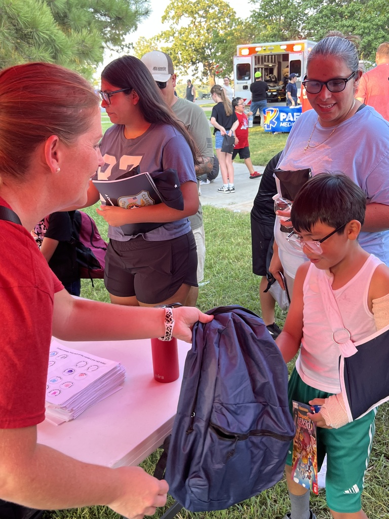 Students receiving their free backpacks