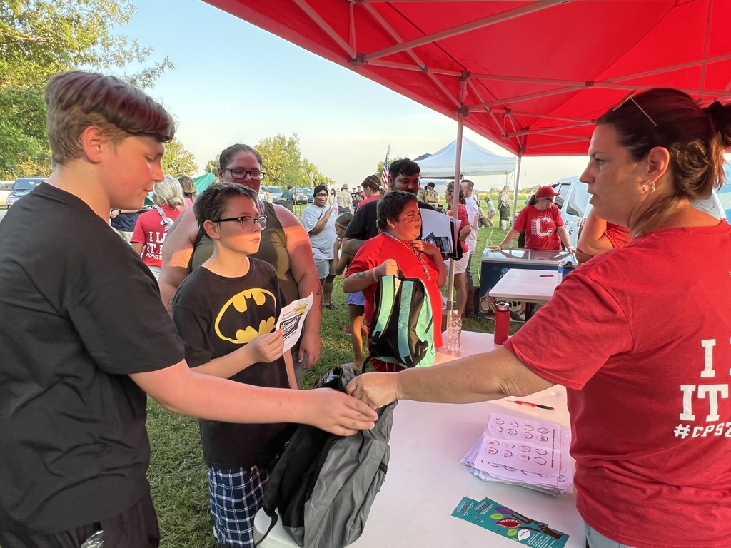 Students receiving their free backpacks
