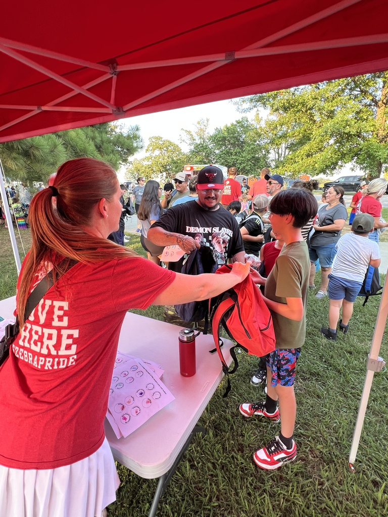 Students receiving their free backpacks