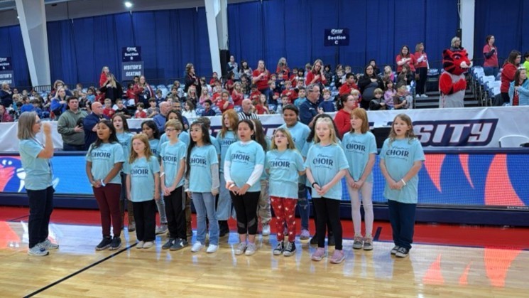 Claremont Choir singing at an RSU game