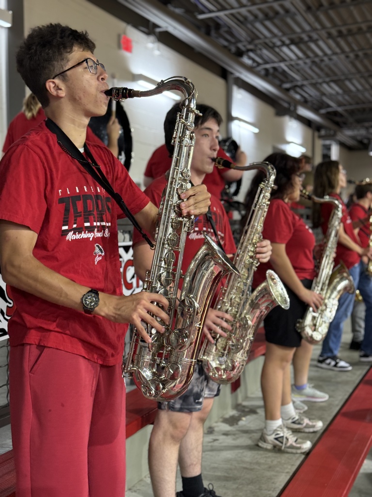 Students playing saxophones at the pep assembly 