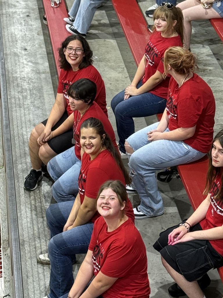 Colorguard smiling at a pep assembly 
