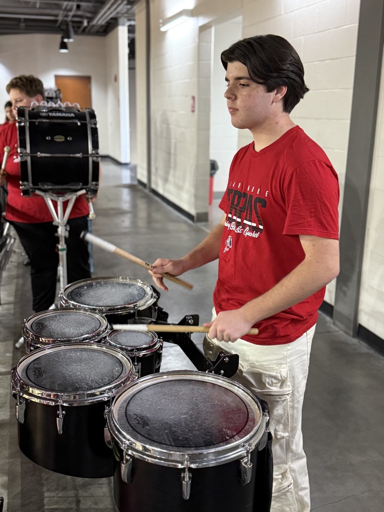 student playing a drum during the pep assembly