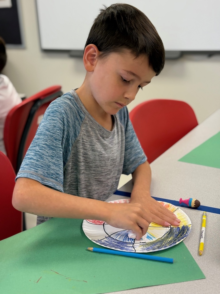 student diligently working on his color wheel