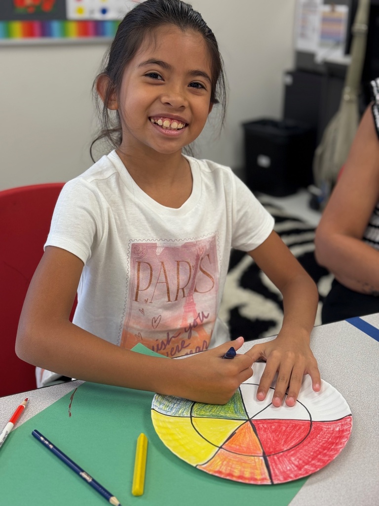 student smiling and working in art