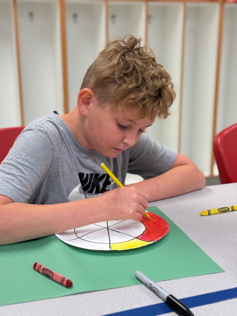 student working hard and coloring his color wheel