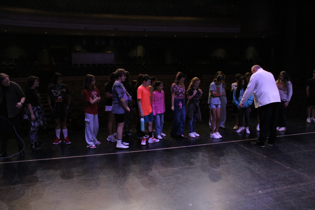Dr. Adkins on stage with jr high drama
