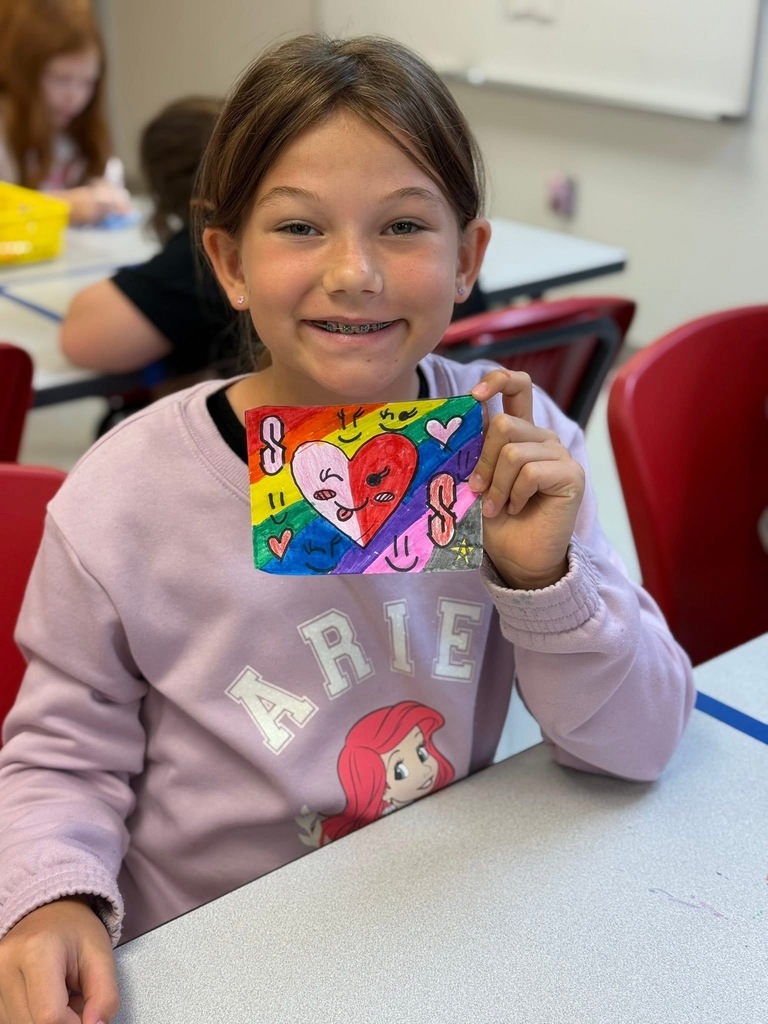 Student showing off her art work