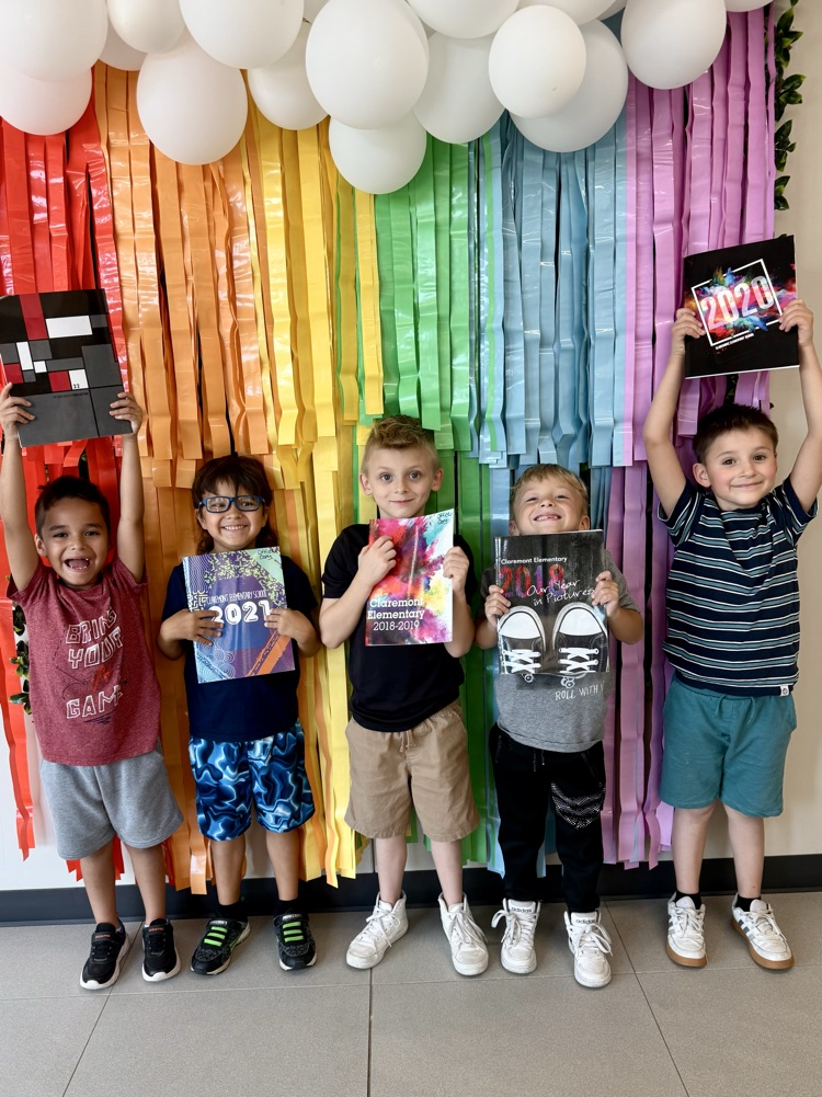 boys holding yearbook