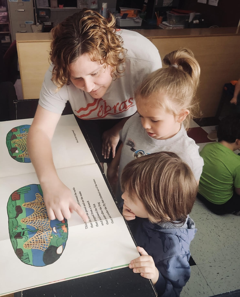 teacher reading with two students