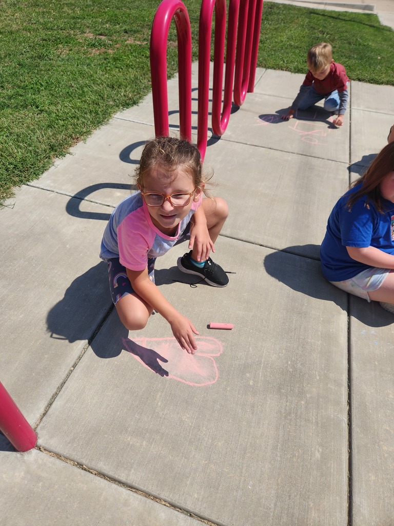 students playing with chalk outside