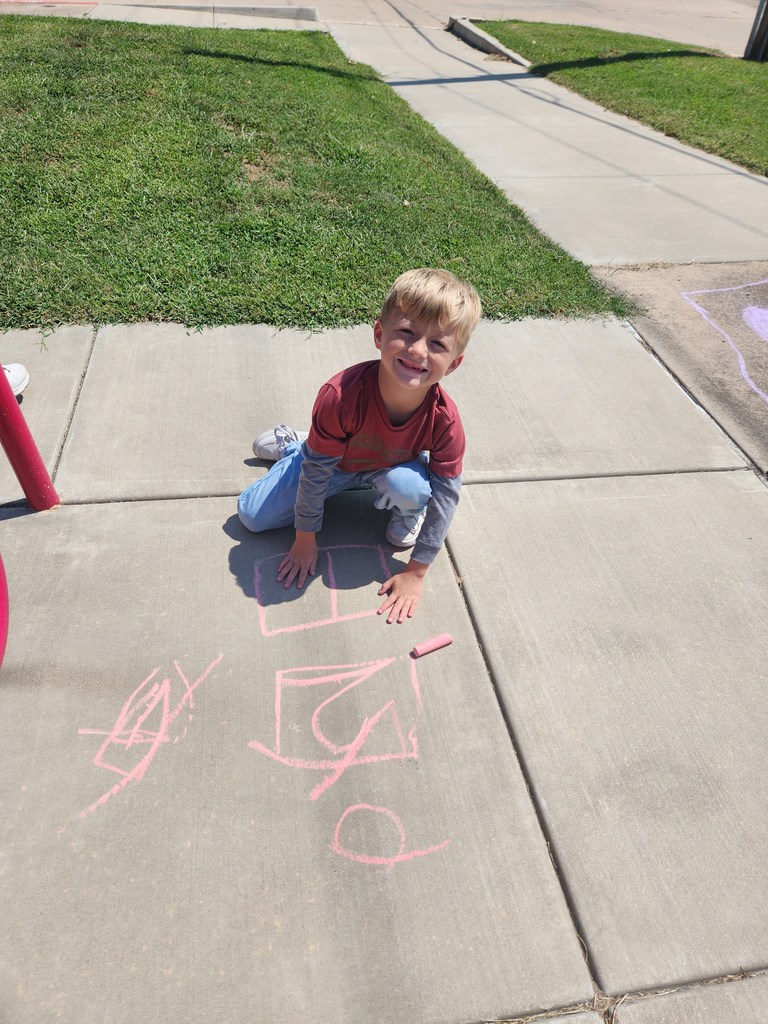 students playing with chalk outside