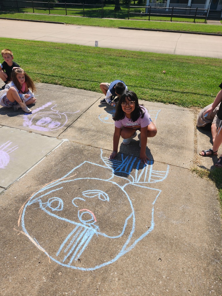 students playing with chalk outside