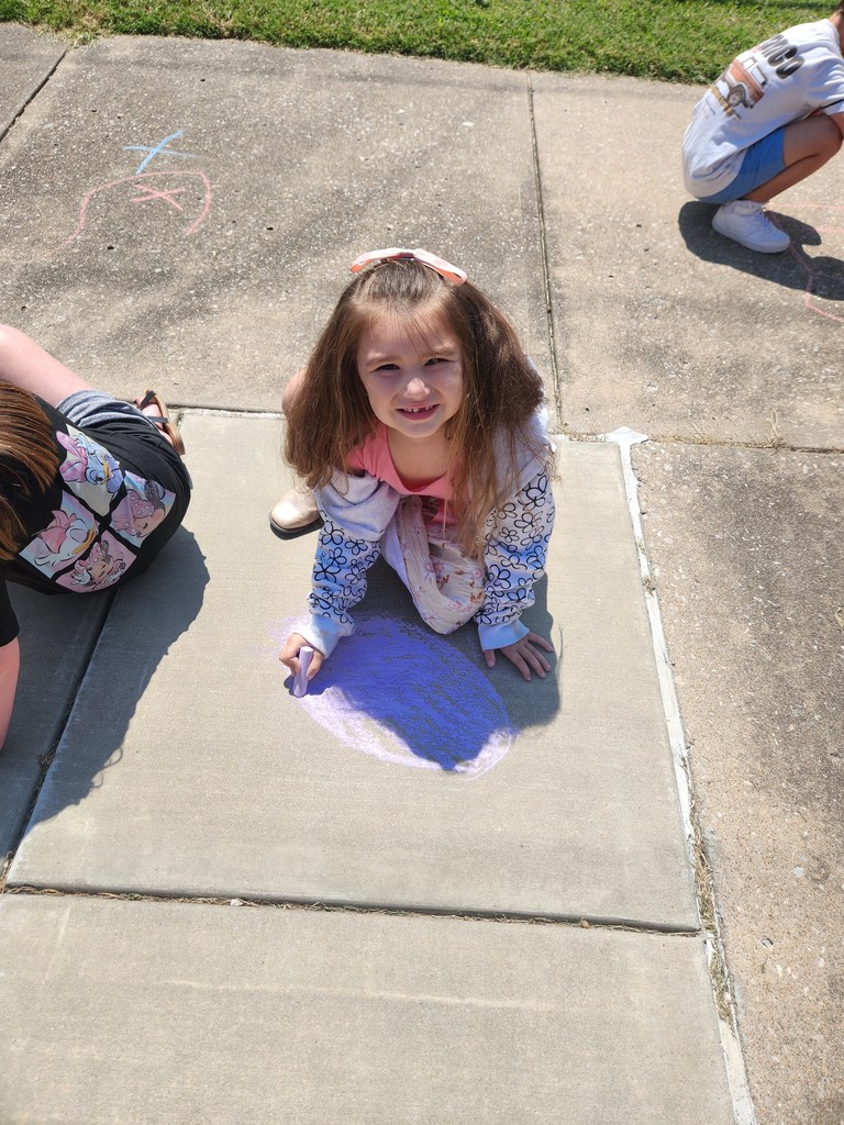 students playing with chalk outside