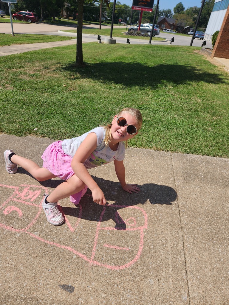 students playing with chalk outside