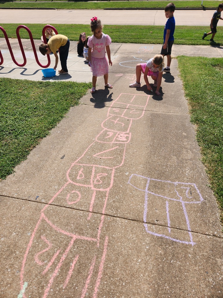 students playing with chalk outside