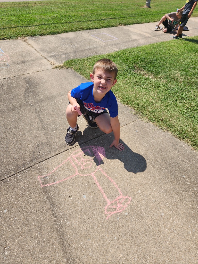 students playing with chalk outside