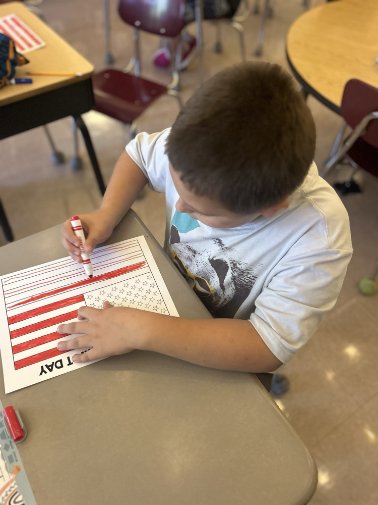 student coloring American flag 