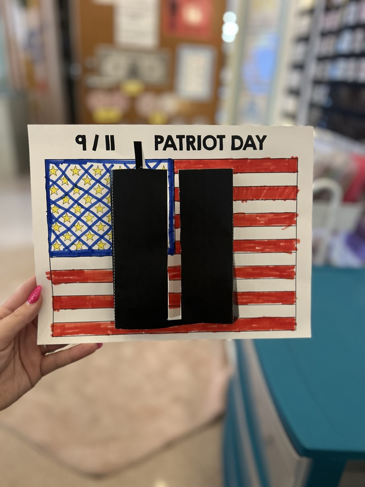 student coloring American flag 