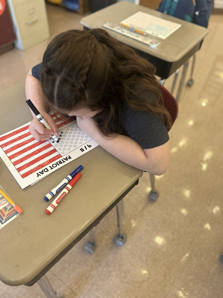 student coloring American flag 