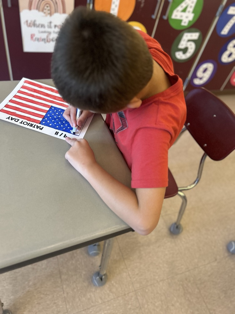 student coloring American flag 