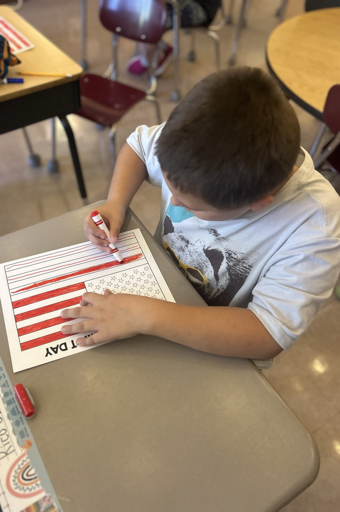 student coloring American flag 