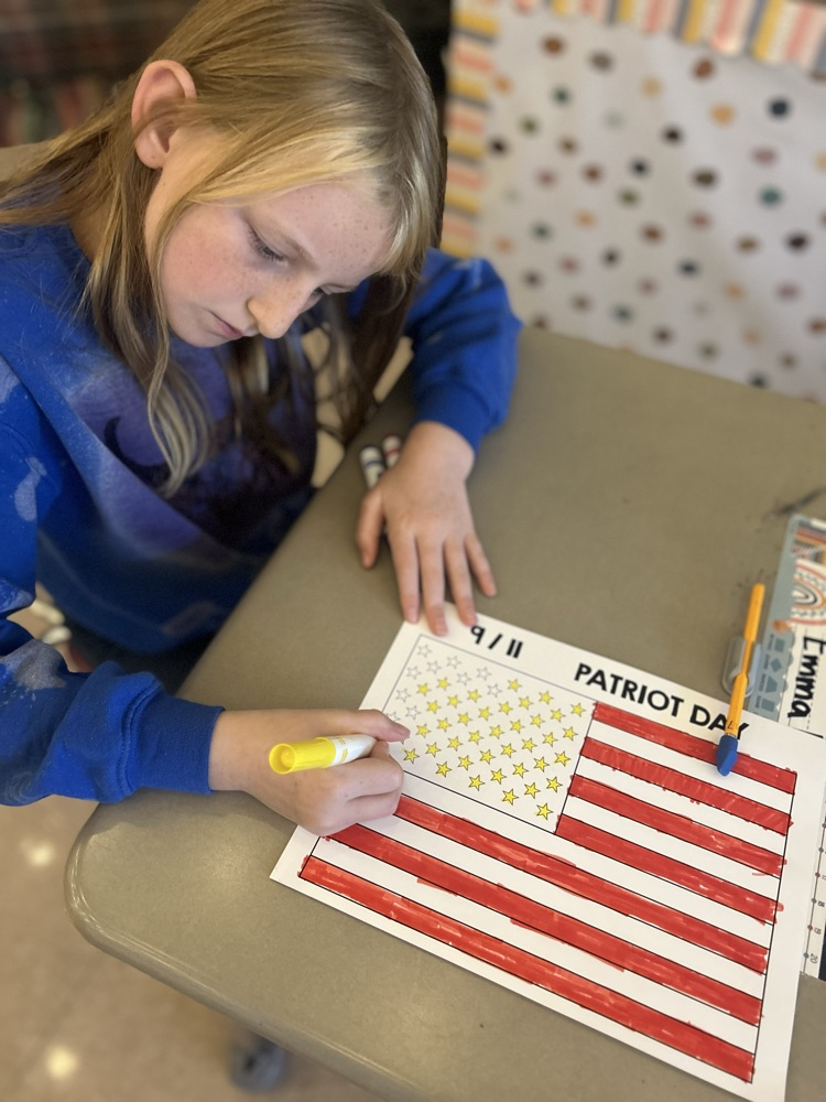 student coloring American flag 