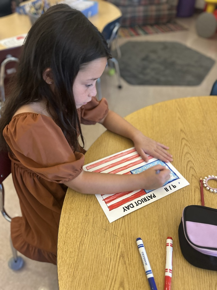 student coloring American flag 