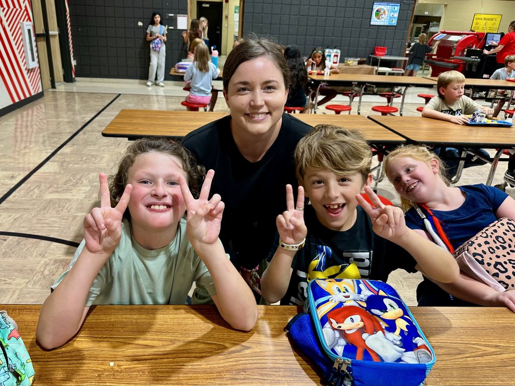 teacher and students at lunch