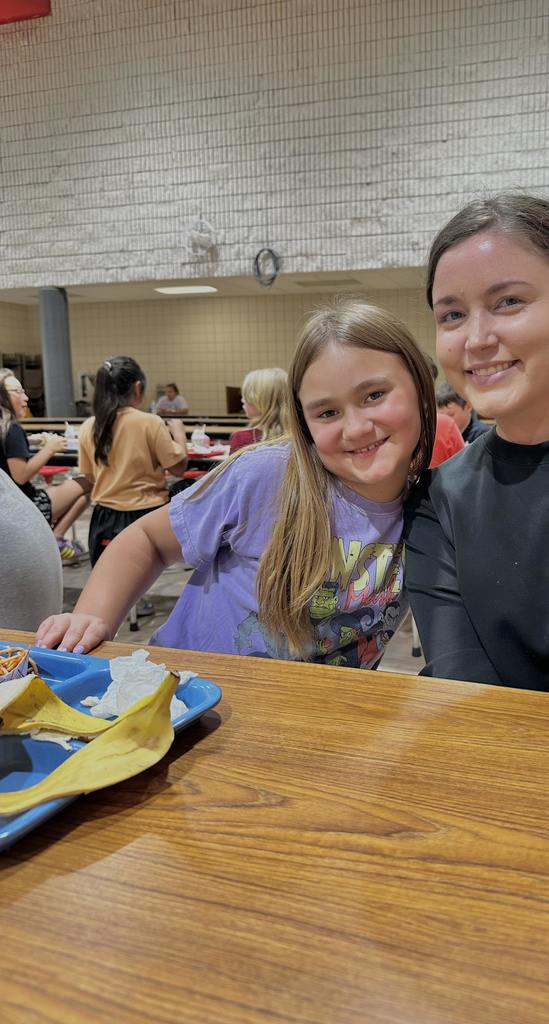 teacher and students at lunch