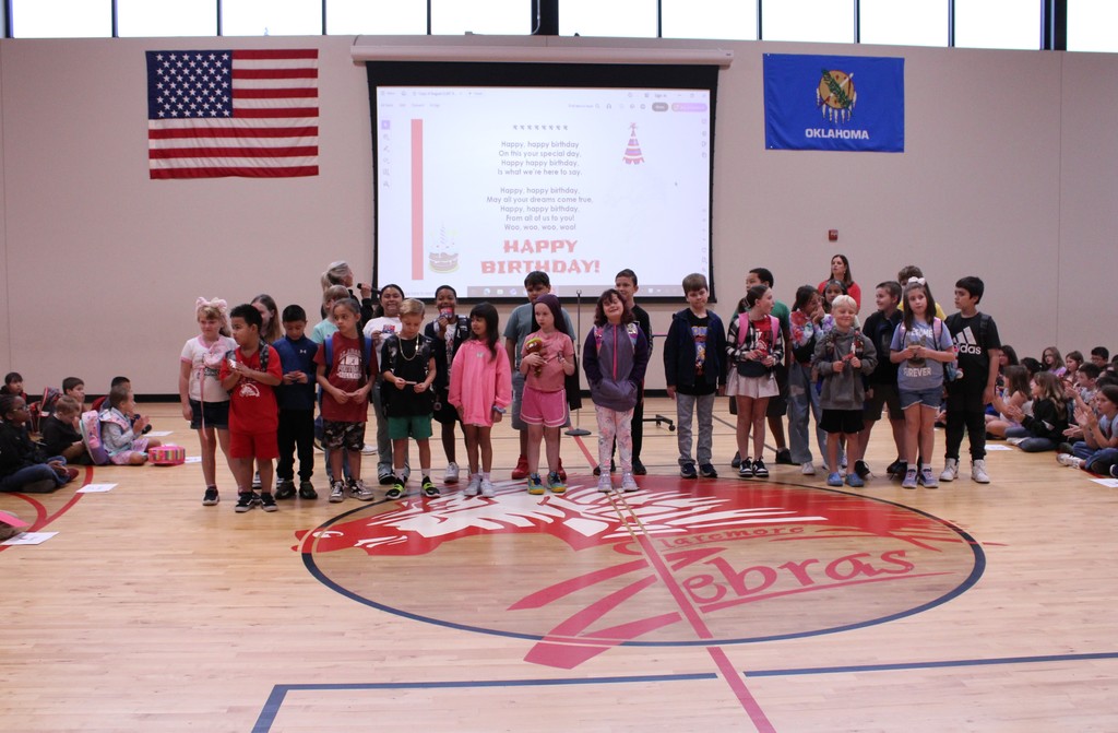 August birthday students standing up front
