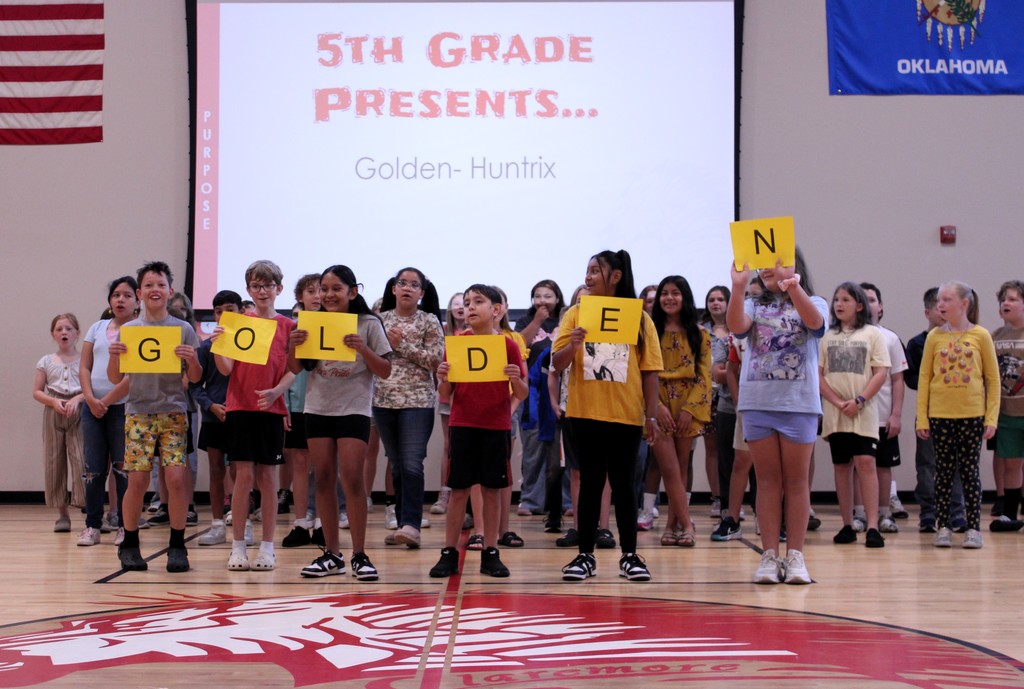 fifth graders holding signs that spell golden