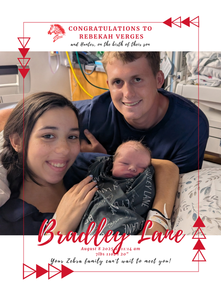 two adults holding new baby wrapped in a blanket 