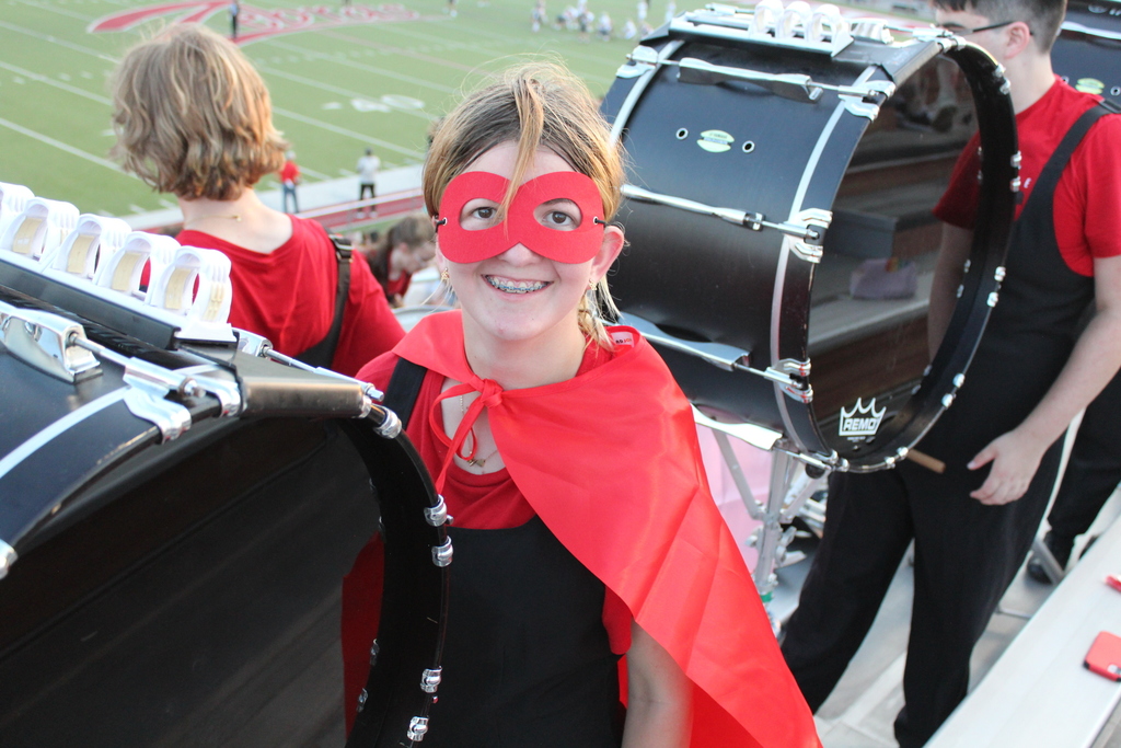 Student in the stands playing the bass drum