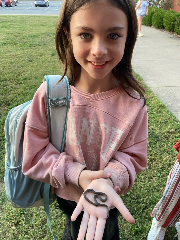 student holding snake