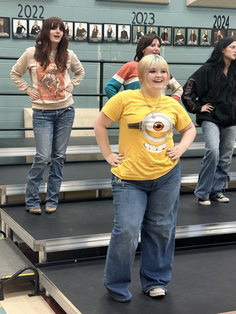 Students in show choir smiling and working on their routine