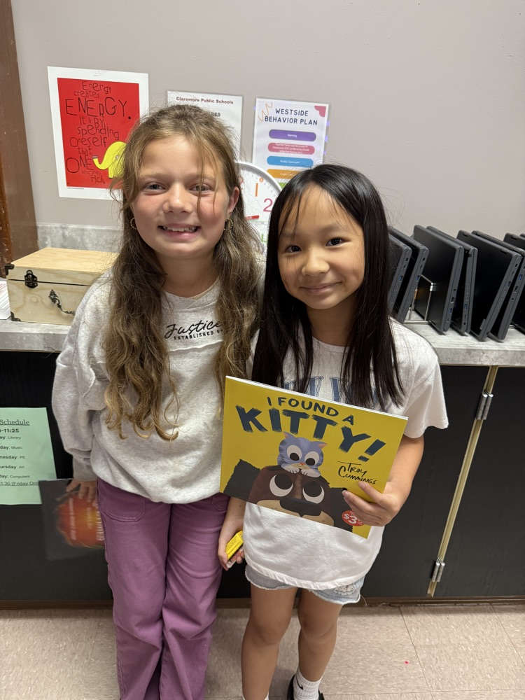 students holding book
