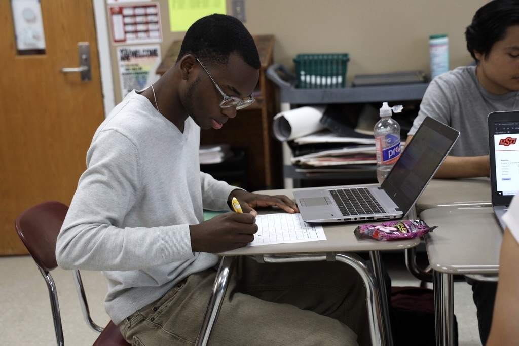 student filling out information on paper