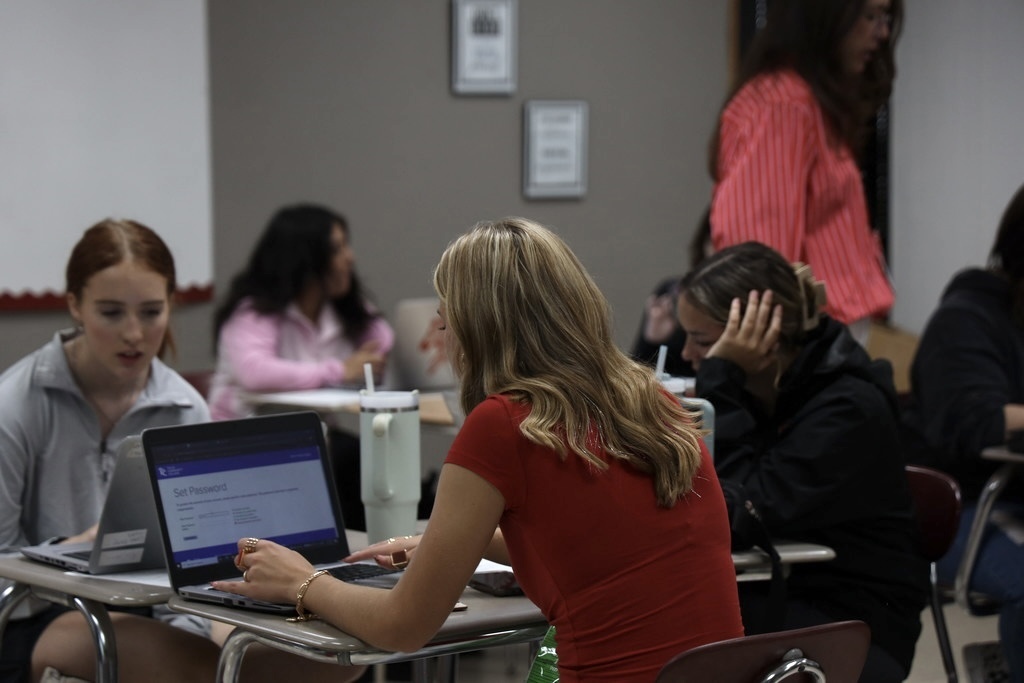 student filling out application on computer