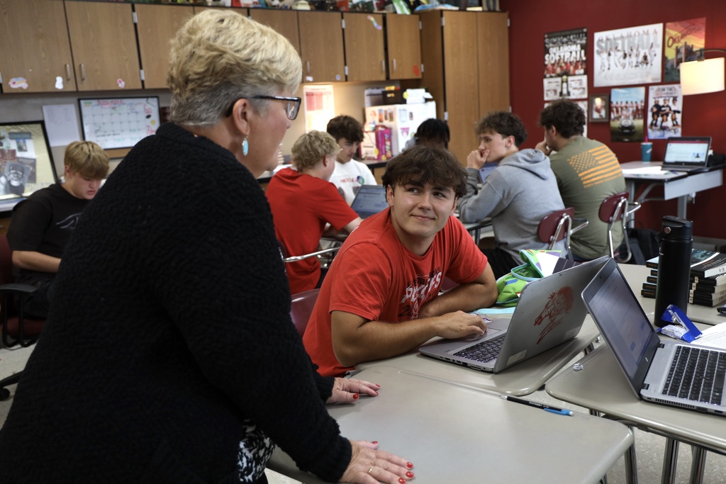 teacher helping student with application