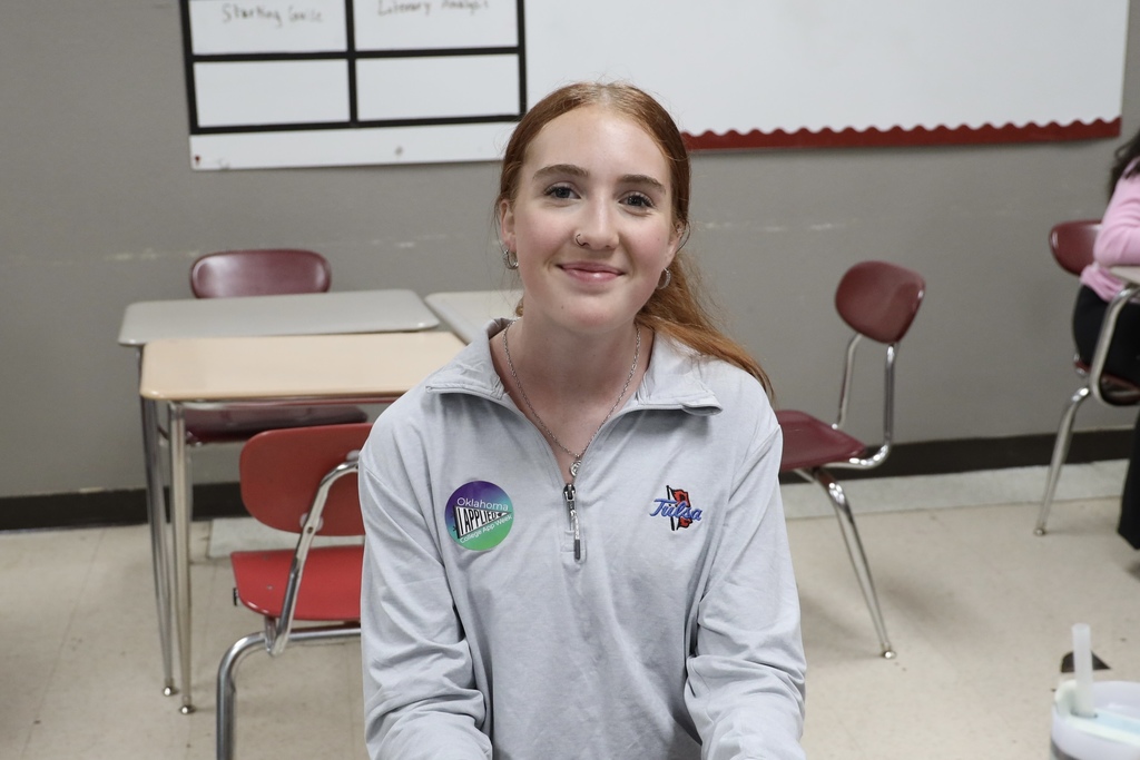 student smiling with an "I applied" sticker