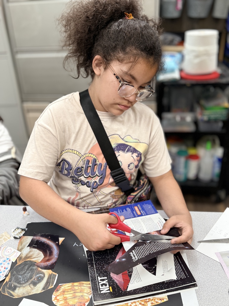 Student cutting out things for her art journal